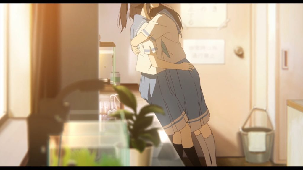 Mizore Yoroizuka and Nozomi Kasaki, two high school girls, tightly hugging each other in a classroom at dusk.